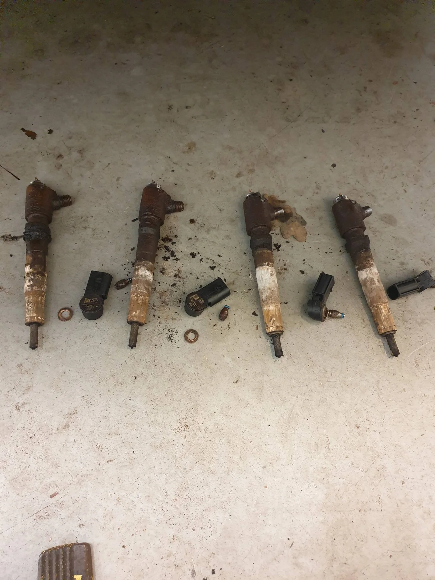 Set of heavily corroded Ford Transit 2.0 litre diesel injectors after removal